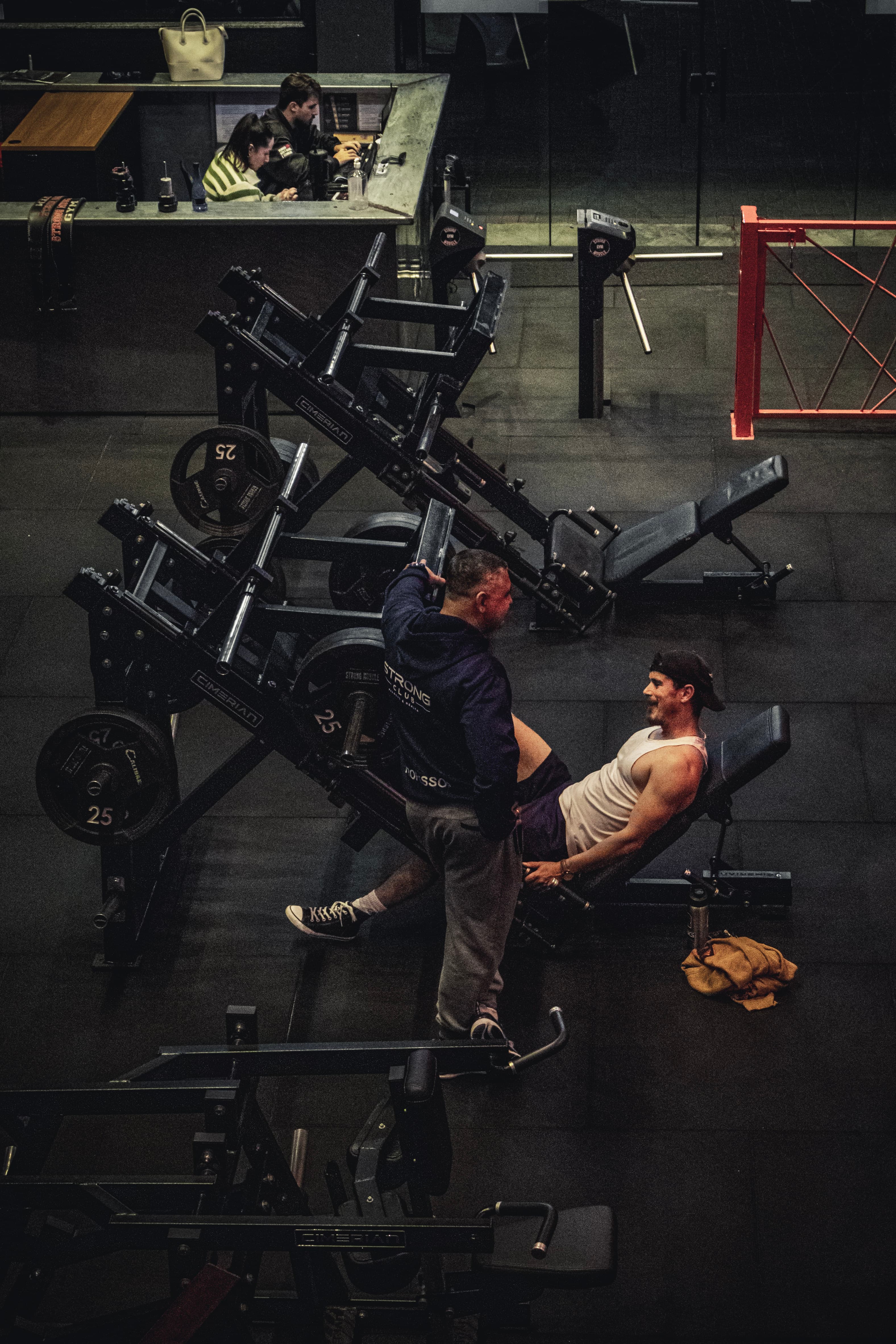 Treino acompanhado por profissional na área de musculação